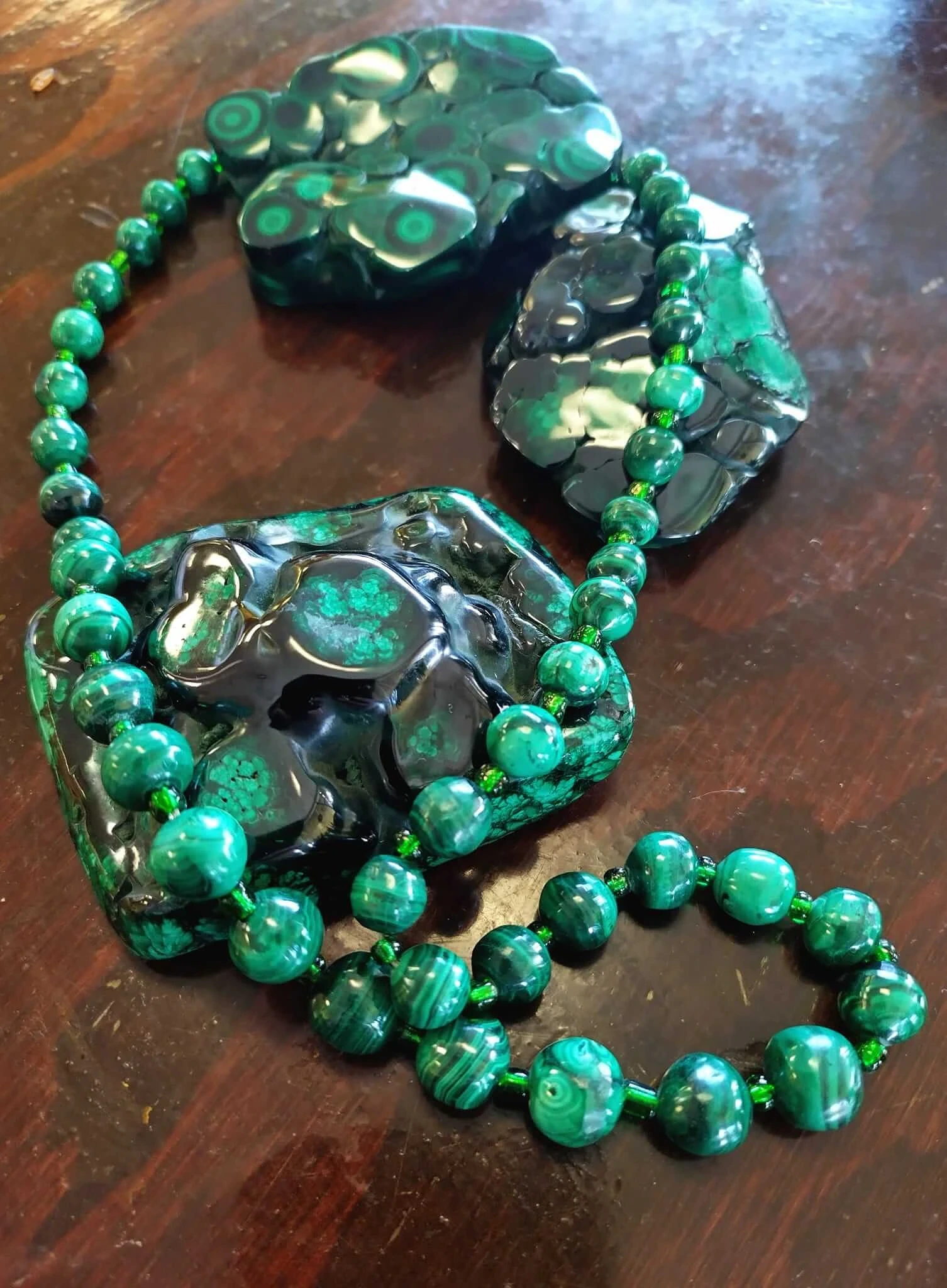 A display of various pieces of malachite crystal