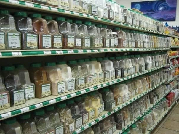 A shelf of loose herb and tea containers